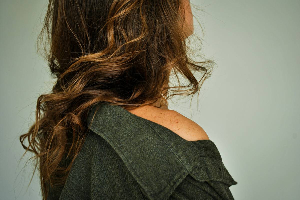 Close-up of seamless lowlight hair creations showing natural depth and contrast in dark brown hair